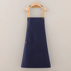 Tablier de travail en coton bleu foncé avec bretelles kaki et poche avant sur cintre
