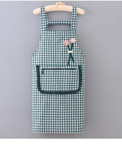 Green and white checkered kitchen apron detail, pocket with zipper and cute flower decor.