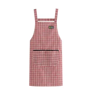 Cotton kitchen apron with plaid pattern, h-back straps and front pocket for cooking.