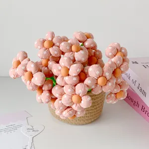 Detailed view of pink fabric flower pens with polka dots in a basket