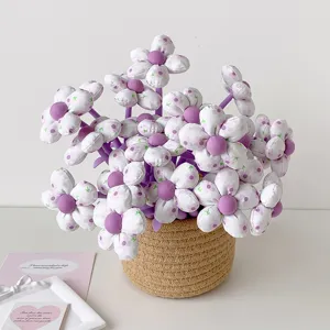 Close-up of fabric flower-topped gel pens arranged in a decorative woven basket
