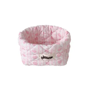 Adorable pink quilted fabric storage basket with bow pattern for desk organization