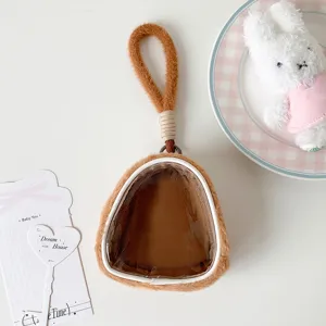 Close-up of brown plush doll display pouch with clear transparent window