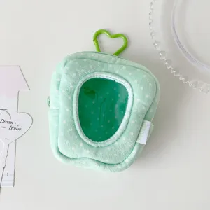 Close-up detail of plush storage bag showing the transparent window and green heart-shaped clip
