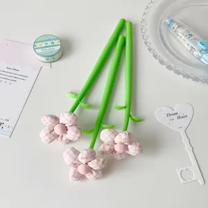 Detailed view of three creative fabric flower pens with pink plaid decorative tops