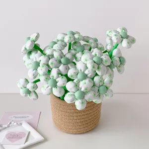 Detail view of cute fabric flower gel pens with green floral pattern in a woven pot