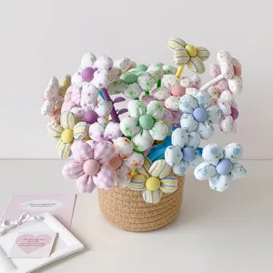 Handmade colorful fabric flower gel pens in a woven straw basket for student gifts