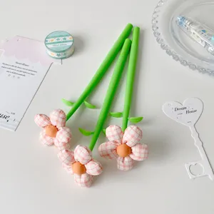 Close-up of three creative fabric flower pens with pink checkered petals