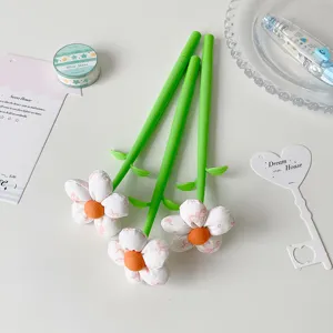 Close-up of creative fabric flower pens with green stems and plush blossoms