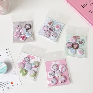 Variety of 25mm cute cartoon mini badges displayed in aesthetic pastel packaging sets