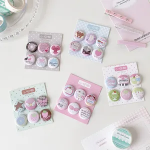 Collection of five colorful sets of cute 25mm cartoon button badges on card backings