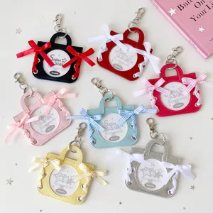 Colorful handbag-shaped badge holders with ribbon bows and clear display windows.