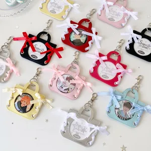 Variety of colorful mini handbag badge display cases with elegant ribbon bow decorations
