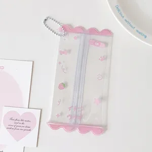 Close-up view of a clear PVC mini doll storage bag with pink accents and bead chain