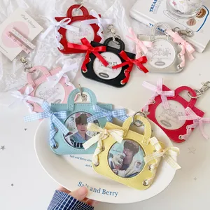Various colors of ballet handbag style badge holders with ribbon bow decorations