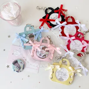 Close-up of ballet handbag-style badge holders in various colors with ribbon bows