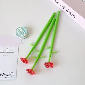 Detailed macro shot of three creative red rose flower ballpoint pens with green stems.
