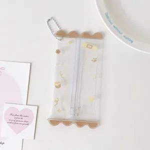 Close-up of a clear PVC mini doll storage pouch with cute prints and a white bead chain