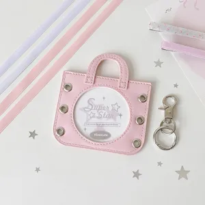 Close-up of pink mini handbag badge holder with decorative silver star accents