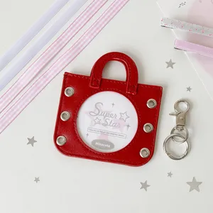 Close-up of red mini handbag badge holder with transparent window for photos
