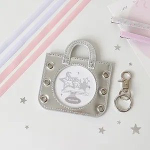 Detail view of silver ballet handbag badge holder with metal eyelets and star confetti