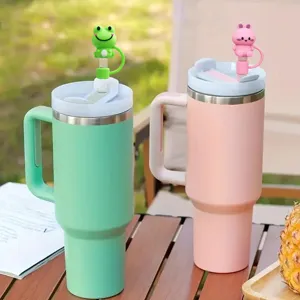 Stainless steel insulated tumbler with cute cartoon animal silicone straw cover and handle.