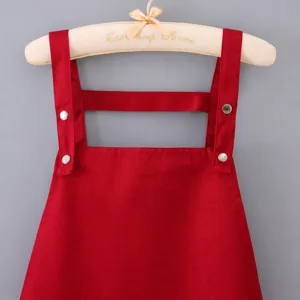 Red waterproof work apron with H-shaped straps, ideal for coffee shop and kitchen use.