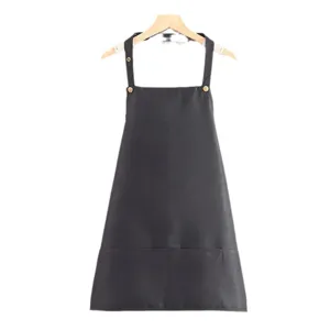 Black kitchen apron with pockets and adjustable straps, durable work wear for cooking and baking.