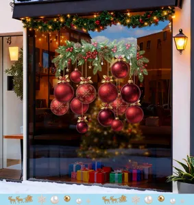 Détail de stickers de boules de Noël rouges festives sur une devanture en verre.
