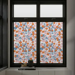 Detail of floral pattern window privacy film with orange and pink flowers on glass