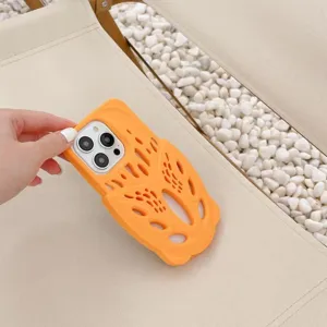 Close-up of orange silicone phone case with unique hollow foam runner design for iPhone.