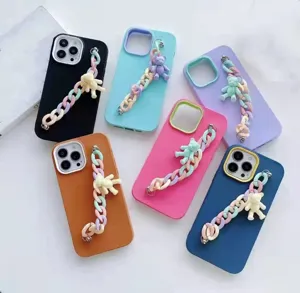 Colorful liquid silicone phone case with pastel chain and cute bear charm pendant details.