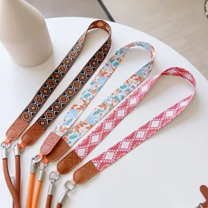Boho style woven phone lanyard with leather ends, colorful retro crossbody strap for mobile.