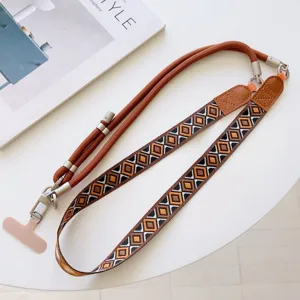 Detailed view of the retro woven geometric phone strap with metal clips and adjustable rope.