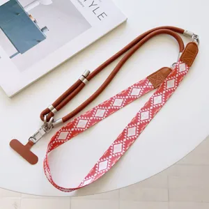 Crossbody phone lanyard strap with red geometric woven band and brown rope, versatile.