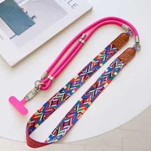 Versatile crossbody phone lanyard with ethnic geometric strap, pink rope and metal hardware.