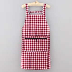 Red white checkered kitchen apron with front pocket and straps for cooking at home.
