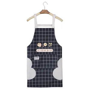 Waterproof kitchen apron with pockets, cute plaid design, wipeable hand towels on sides.
