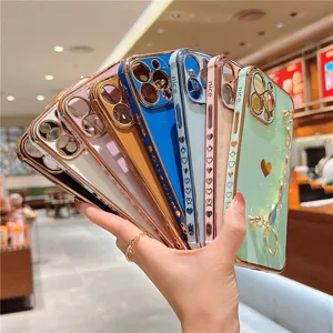 Electroplated wrist chain phone case with cute heart design, available in multiple vibrant colors.
