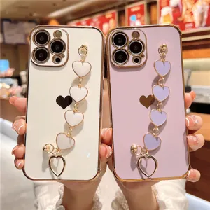 Detail view of electroplated iPhone case with luxury heart wrist chain, stylish phone cover.