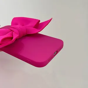 Pink bow phone case detail view, cute aesthetic soft silicone cover for Apple iPhone models.