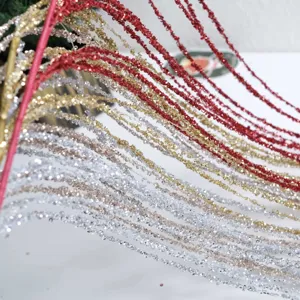 Close-up detail of sparkling glitter branches for Christmas DIY floral arrangements red gold