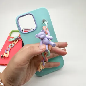 Liquid silicone phone case detail showing colorful chain strap and cute bear pendant design.