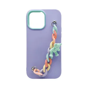 Purple silicone phone case detail with colorful chain strap and cute bear pendant accessory.