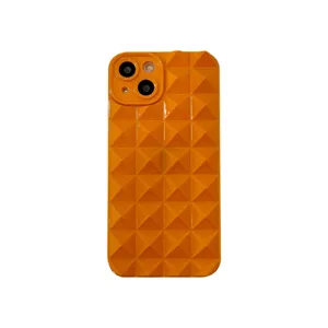 Close-up detail of glossy orange 3D pyramid geometric phone case showcasing soft texture.