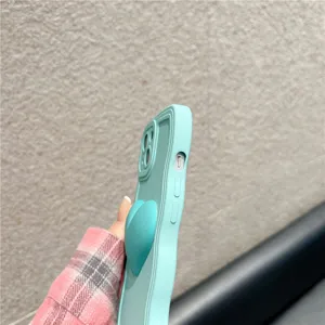 Minimalist solid color silicone wave phone case with cute heart grip for smartphones.