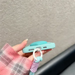Silicone phone case detail showing bottom speaker holes, charging port and colorful braided lanyard.