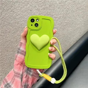 Green silicone wavy phone case with 3D heart decor and matching lanyard, closeup detail view.