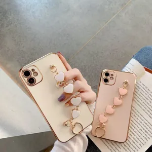 Detailed view of electroplated heart chain phone case with wristband and bracket design.