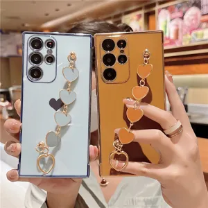 Electroplated heart wrist strap phone case compatible with Samsung, stylish anti-drop soft cover.
